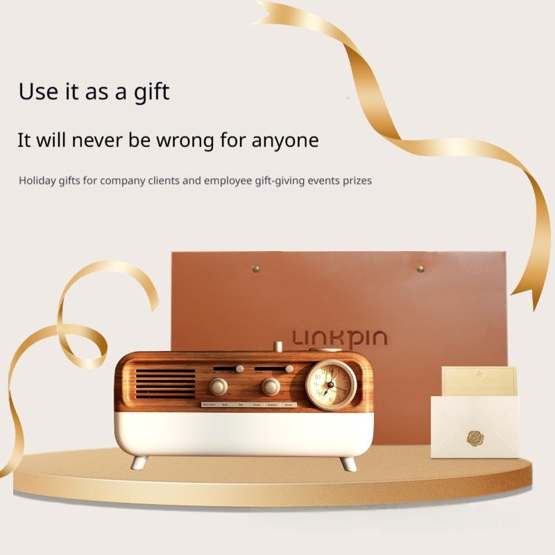 The retro speaker presented as a gift with a kraft paper gift bag and golden ribbon in the background