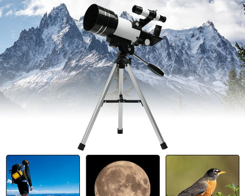 Telescope set up outdoors with a mountain landscape behind it