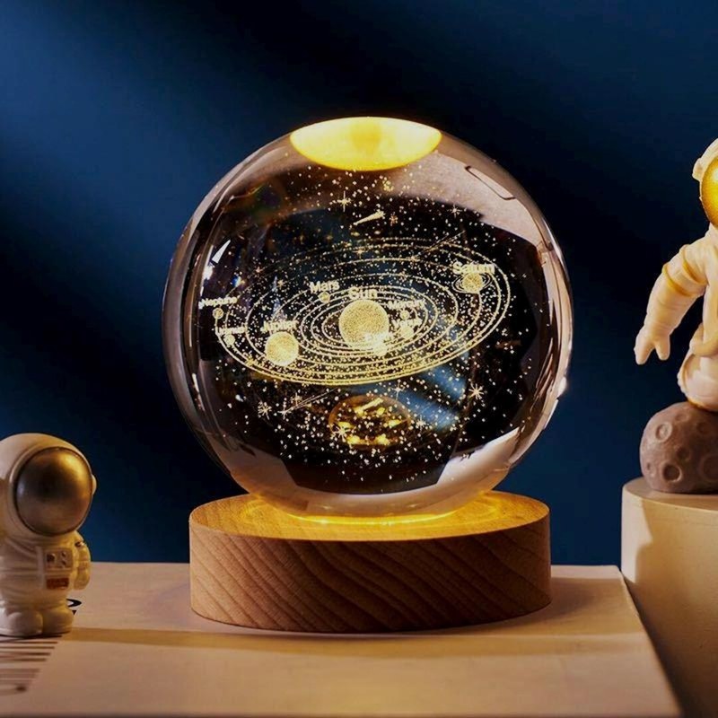 3D Solar System crystal ball packshot view with engraved planets and warm LED wooden base