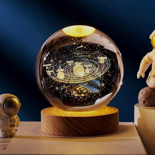 3D Solar System crystal ball packshot view with engraved planets and warm LED wooden base