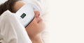 Woman reclining with the smart eye massager during a relaxing wind-down moment