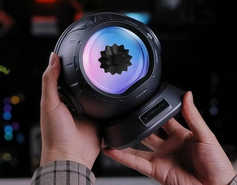 Hands holding the compact ferrofluid Bluetooth speaker to show its size
