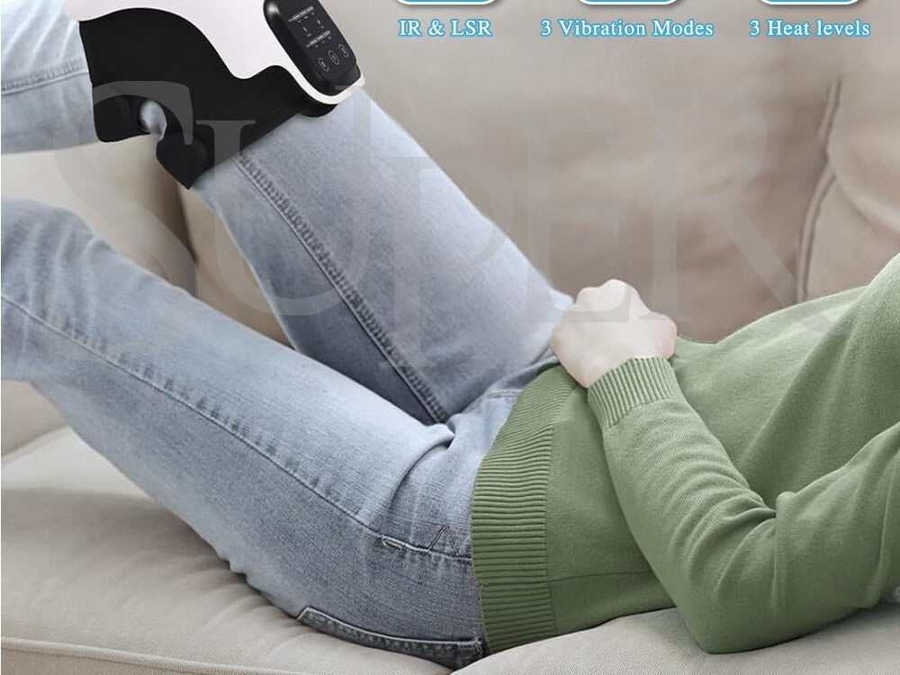 Woman reclining on a couch in a green sweater with the Smart Knee Massager wrapped around her knee.