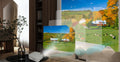 Home cinema projector on a side table casting a large image on the living room wall