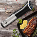 Precision Sous Vide Cooker on rustic wooden board next to a perfectly grilled steak with lemon slices and herbs — the restaurant-grade result you get at home.